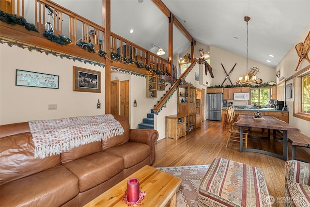 2290 Riffle Dr, Leavenworth, WA 98826 - living room with high vaulted ceiling, a chandelier, stairway, wood finished floors, and recessed lighting