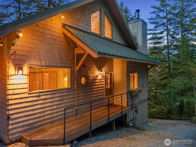 2290 Riffle Dr, Leavenworth, WA 98826 - view of home's exterior with a standing seam roof, a chimney, and a metal roof