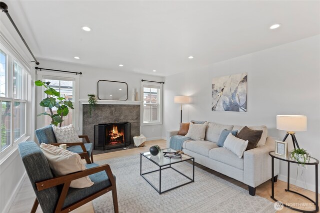 8315 24th Ave NW, Seattle, WA 98117 - living room featuring healthy amount of natural light, recessed lighting, light wood-style flooring, and a fireplace