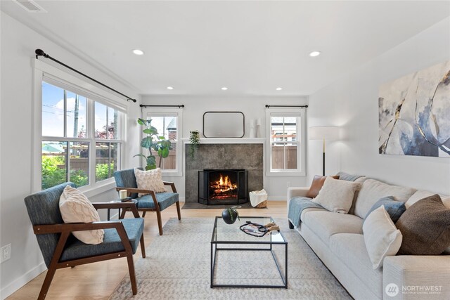 8315 24th Ave NW, Seattle, WA 98117 - living room with light wood-type flooring, a high end fireplace, and recessed lighting