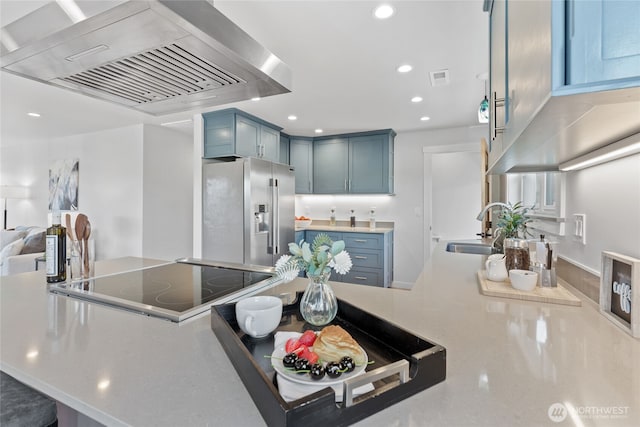 8315 24th Ave NW, Seattle, WA 98117 - kitchen with stainless steel fridge with ice dispenser, ventilation hood, black electric cooktop, recessed lighting, and a peninsula