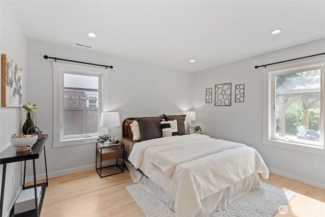 8315 24th Ave NW, Seattle, WA 98117 - bedroom featuring multiple windows, light wood-style floors, and recessed lighting