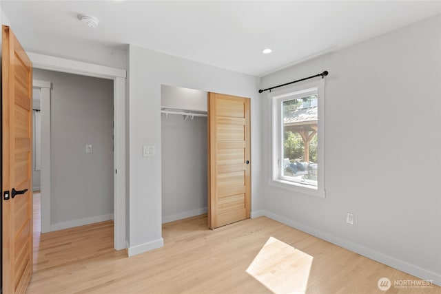 8315 24th Ave NW, Seattle, WA 98117 - unfurnished bedroom with light wood finished floors, a closet, and recessed lighting