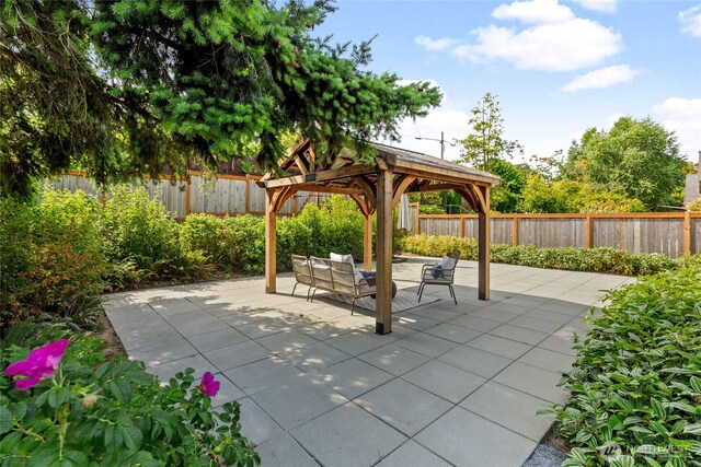 8315 24th Ave NW, Seattle, WA 98117 - fenced backyard with a gazebo, an outdoor living space, and a patio area