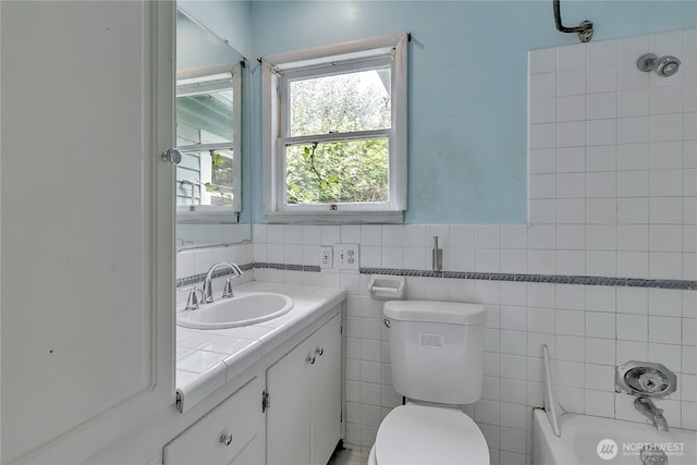 2209 S Talbot Rd, Renton, WA 98055 - bathroom with vanity, a tub to relax in, and tile walls