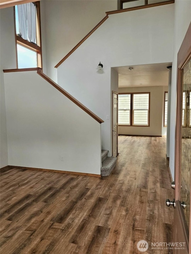 741 G St SW, Tumwater, WA 98512 - unfurnished living room featuring stairs, a high ceiling, and wood finished floors