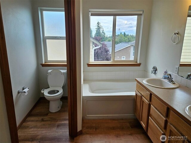 741 G St SW, Tumwater, WA 98512 - full bath featuring a bath, wood finished floors, plenty of natural light, and double vanity