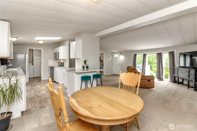 3010 248th Street Ct E, Spanaway, WA 98387 - dining area with light colored carpet and washer / clothes dryer
