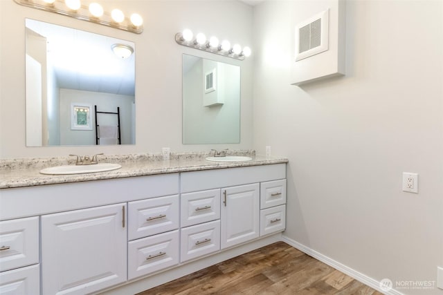 3010 248th Street Ct E, Spanaway, WA 98387 - full bathroom with double vanity and wood finished floors