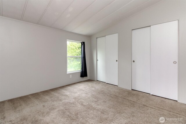 3010 248th Street Ct E, Spanaway, WA 98387 - unfurnished bedroom with lofted ceiling, carpet floors, and multiple closets
