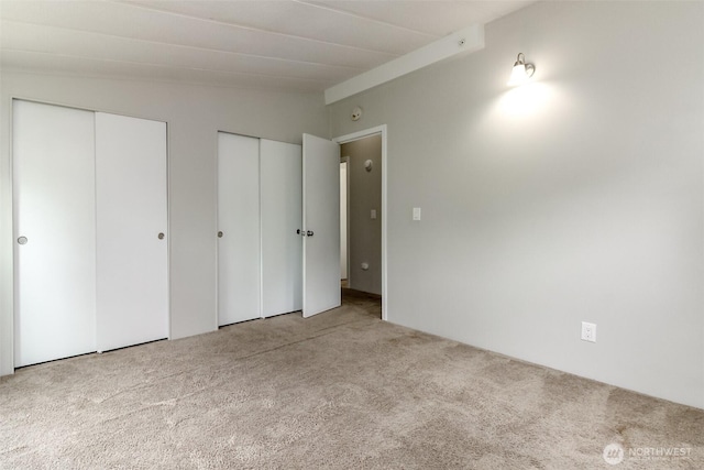 3010 248th Street Ct E, Spanaway, WA 98387 - unfurnished bedroom with two closets, carpet floors, and lofted ceiling