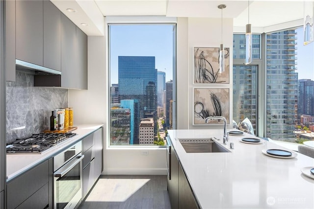 2510 6th Ave Unit 1704, Seattle, WA 98121 - kitchen featuring stainless steel appliances, modern cabinets, a skyline view, and light countertops