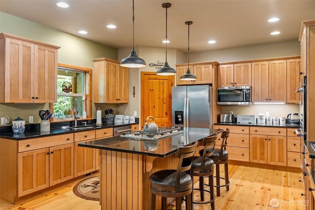 143 Scenic Ln, Mossyrock, WA 98564 - kitchen with stainless steel appliances, light wood-style flooring, recessed lighting, a center island, and a breakfast bar