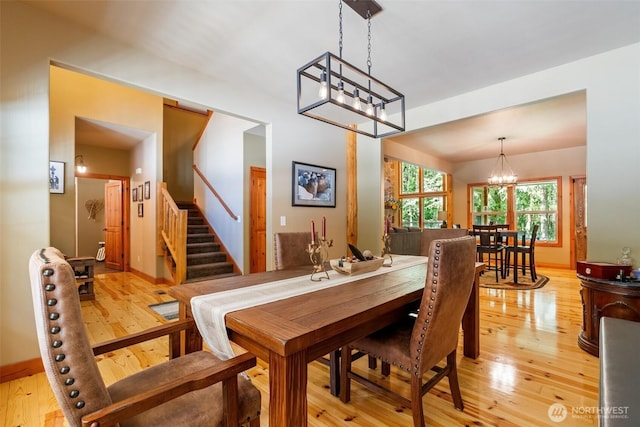 143 Scenic Ln, Mossyrock, WA 98564 - dining space with light wood-style flooring, a chandelier, and stairs