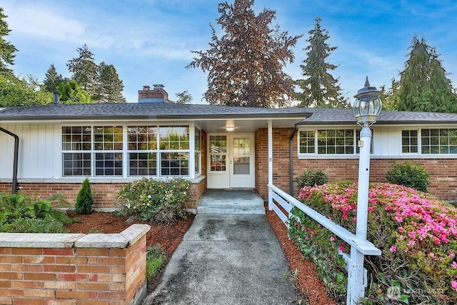 731 Maplewood Ave, Kent, WA 98030 - view of front of house with brick siding, board and batten siding, and a chimney