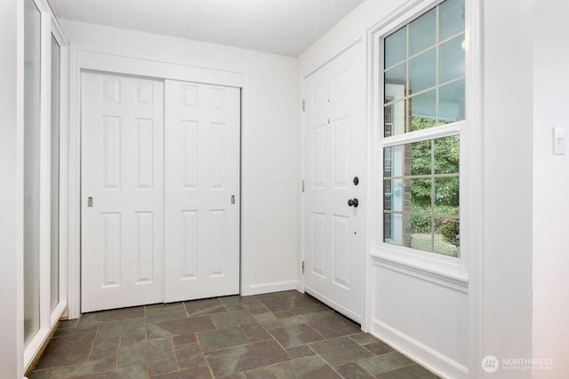 731 Maplewood Ave, Kent, WA 98030 - doorway with dark stone finish flooring and a textured ceiling