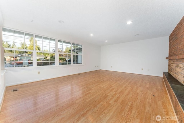 731 Maplewood Ave, Kent, WA 98030 - unfurnished living room with light wood finished floors and recessed lighting