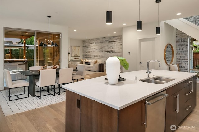 10637 128th Ave NE, Kirkland, WA 98033 - kitchen featuring light wood-style floors, stainless steel dishwasher, light countertops, hanging light fixtures, and recessed lighting