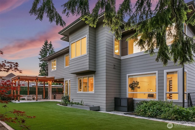 10637 128th Ave NE, Kirkland, WA 98033 - back of house at dusk featuring a patio area and a yard
