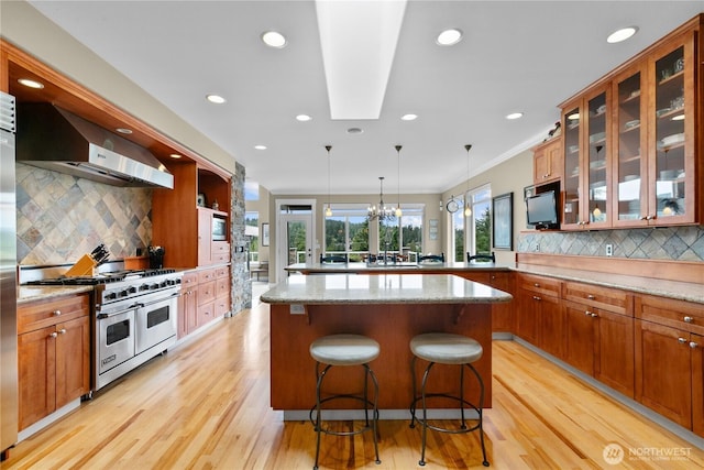 60 Marigold Dr, Bellingham, WA 98229 - kitchen with appliances with stainless steel finishes, extractor fan, a peninsula, tasteful backsplash, and light wood-style floors