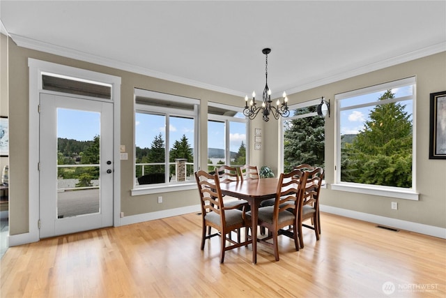 60 Marigold Dr, Bellingham, WA 98229 - dining area featuring crown molding, a chandelier, plenty of natural light, and light wood-type flooring