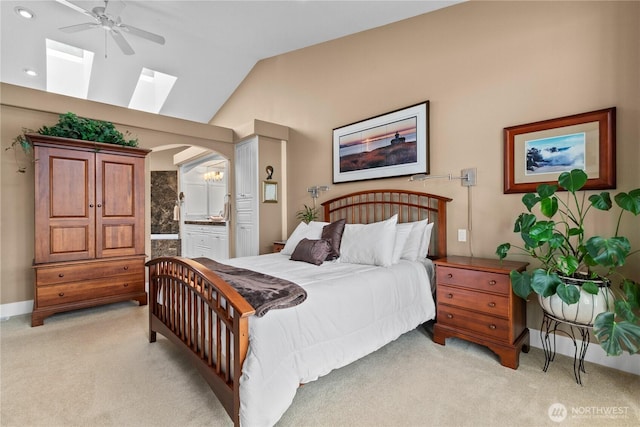 60 Marigold Dr, Bellingham, WA 98229 - bedroom featuring a skylight, light colored carpet, ensuite bath, arched walkways, and lofted ceiling