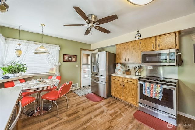 107 Peters Crk, Randle, WA 98377 - kitchen featuring appliances with stainless steel finishes, light wood finished floors, light countertops, and ceiling fan