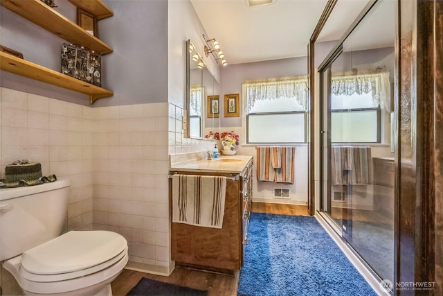 107 Peters Crk, Randle, WA 98377 - full bathroom with tile walls, vanity, wood finished floors, and a stall shower