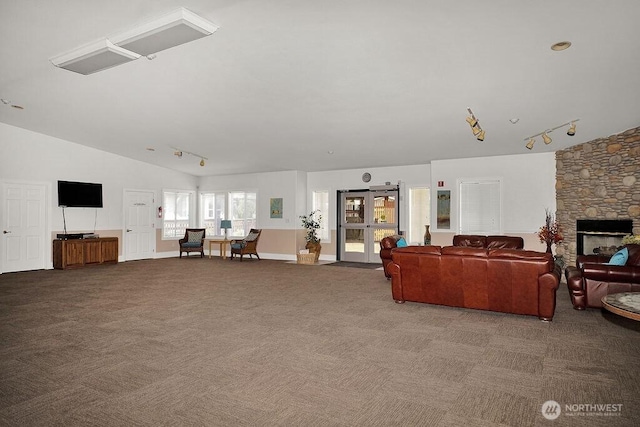 24027 222nd Pl SE Unit 88, Maple Valley, WA 98038 - carpeted living area with rail lighting, lofted ceiling, and a stone fireplace