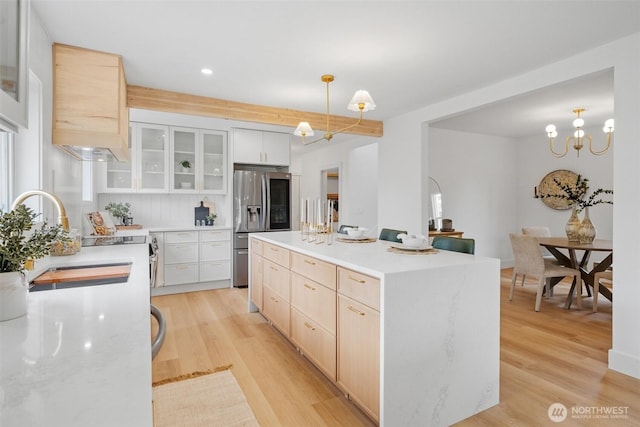 4658 N Defiance St, Tacoma, WA 98407 - kitchen with stainless steel fridge, a chandelier, light brown cabinetry, light wood finished floors, and recessed lighting