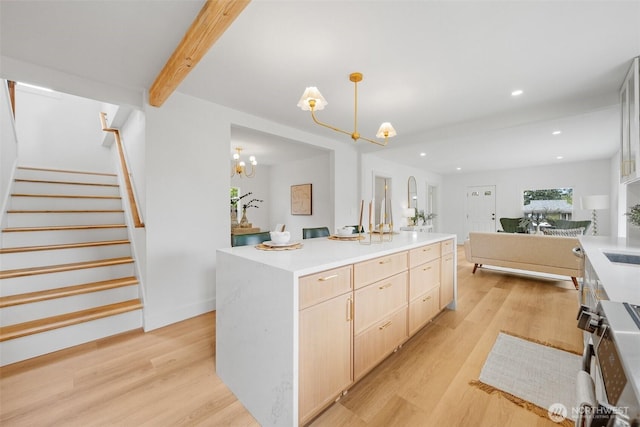 4658 N Defiance St, Tacoma, WA 98407 - kitchen featuring light brown cabinets, a chandelier, light wood-style floors, a center island, and light countertops