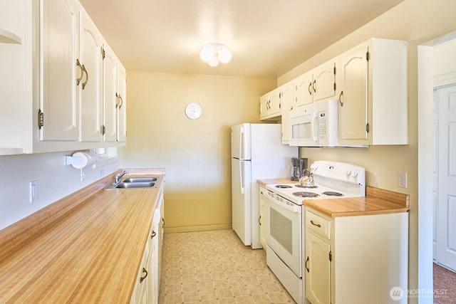 210 26th St NW Unit 201/2, Long Beach, WA 98631 - kitchen featuring white appliances, light flooring, and white cabinets