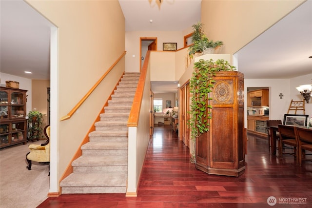 34059 Bridge View Dr NE, Kingston, WA 98346 - staircase featuring wood finished floors and a chandelier