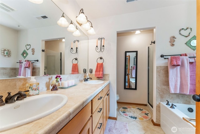 34059 Bridge View Dr NE, Kingston, WA 98346 - bathroom featuring double vanity, a garden tub, tile patterned floors, and a shower with shower door
