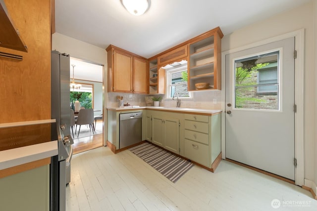 7310 10th Ave NW, Seattle, WA 98117 - kitchen featuring stainless steel appliances, open shelves, light countertops, backsplash, and light wood-style flooring