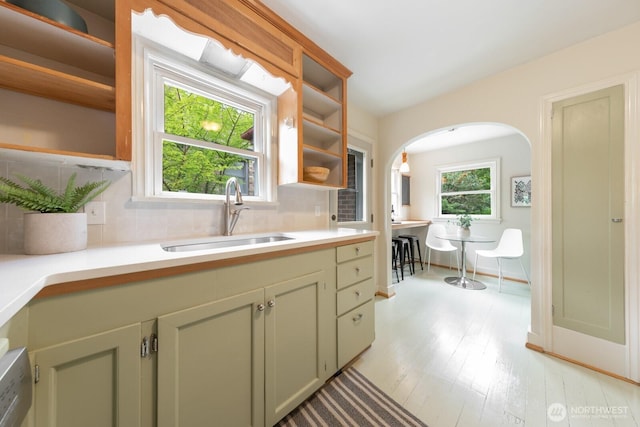 7310 10th Ave NW, Seattle, WA 98117 - kitchen with open shelves, backsplash, arched walkways, and light countertops
