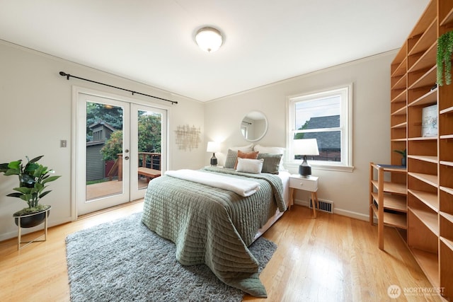 7310 10th Ave NW, Seattle, WA 98117 - bedroom with light wood-style floors, access to exterior, french doors, and ornamental molding