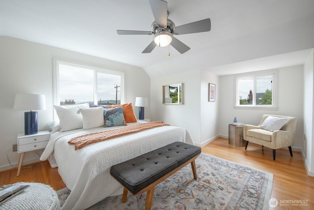 7310 10th Ave NW, Seattle, WA 98117 - bedroom with multiple windows, light wood-style flooring, ceiling fan, and vaulted ceiling