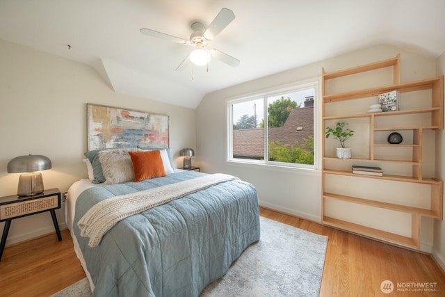 7310 10th Ave NW, Seattle, WA 98117 - bedroom featuring vaulted ceiling, wood finished floors, and a ceiling fan