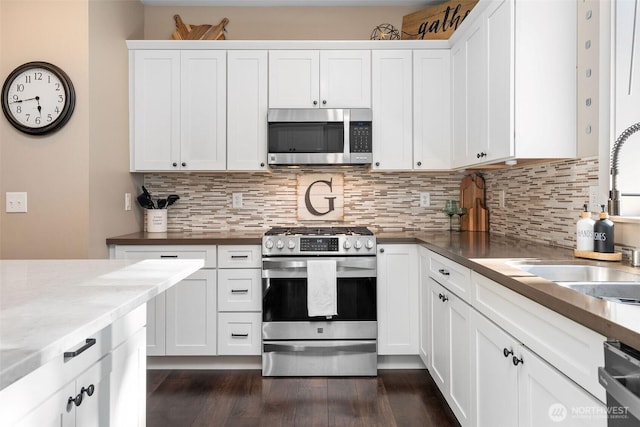 7235 20th Ave SE Unit A & B, Lacey, WA 98503 - kitchen with stainless steel appliances, tasteful backsplash, dark wood finished floors, and white cabinets