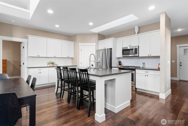7235 20th Ave SE Unit A & B, Lacey, WA 98503 - kitchen featuring stainless steel appliances, a skylight, dark countertops, decorative backsplash, and recessed lighting