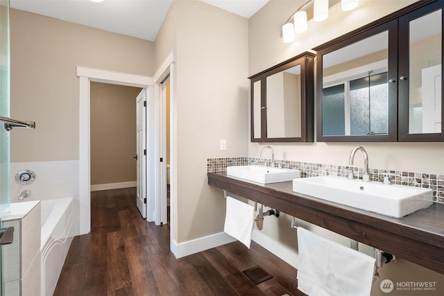 7235 20th Ave SE Unit A & B, Lacey, WA 98503 - bathroom featuring a garden tub, wood finished floors, decorative backsplash, and double vanity