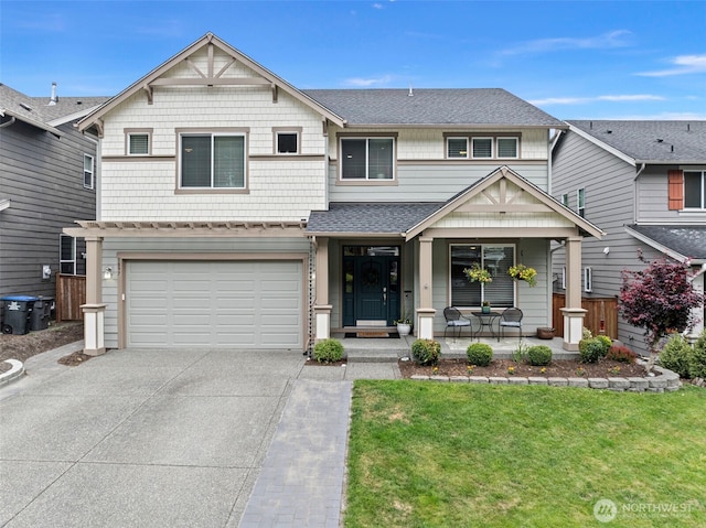 1897 Claret Loop NW, Poulsbo, WA 98370 - view of front of house featuring a porch, concrete driveway, a front yard, a garage, and roof with shingles