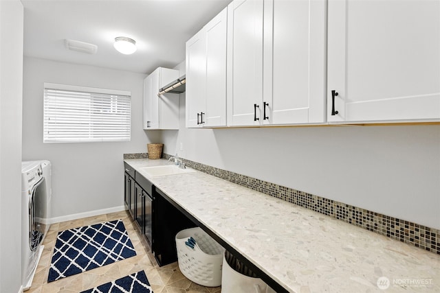 1897 Claret Loop NW, Poulsbo, WA 98370 - washroom featuring washing machine and clothes dryer, cabinet space, and light tile patterned floors