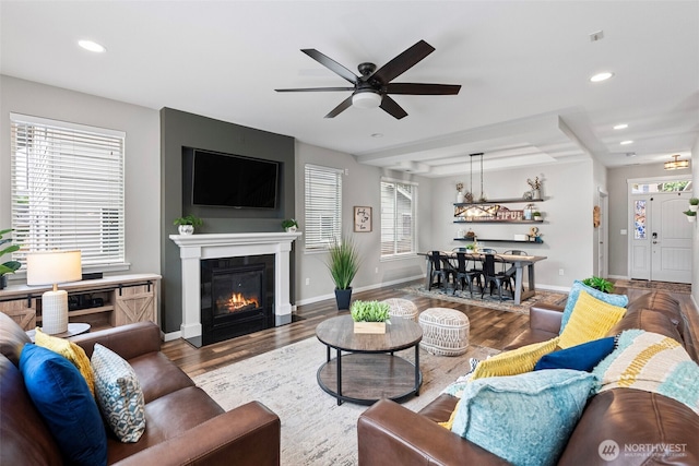 1897 Claret Loop NW, Poulsbo, WA 98370 - living area featuring wood finished floors, a ceiling fan, a glass covered fireplace, and recessed lighting