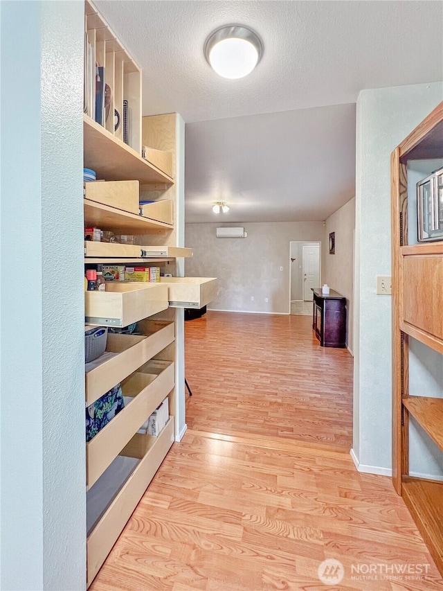 11411 208th Ave E, Bonney Lake, WA 98391 - hall featuring wood finished floors, a wall unit AC, and a textured ceiling
