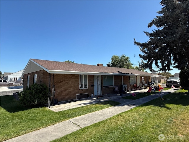 11311133 W Ivy Ave, Moses Lake, WA 98837 - rear view of property with a lawn, brick siding, and a chimney