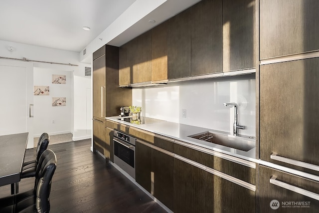 1808 Minor Ave Unit 3005, Seattle, WA 98101 - kitchen featuring oven, black electric stovetop, dark wood-style floors, light countertops, and dark brown cabinets