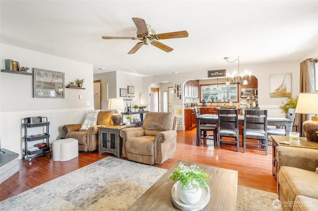 407 Offut Dr, Moses Lake, WA 98837 - living area with arched walkways, a ceiling fan, and wood finished floors