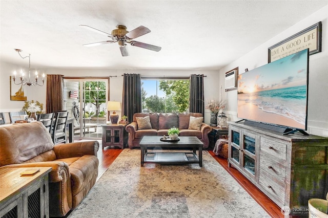 407 Offut Dr, Moses Lake, WA 98837 - living area with wood finished floors, a chandelier, a ceiling fan, and a wall mounted AC